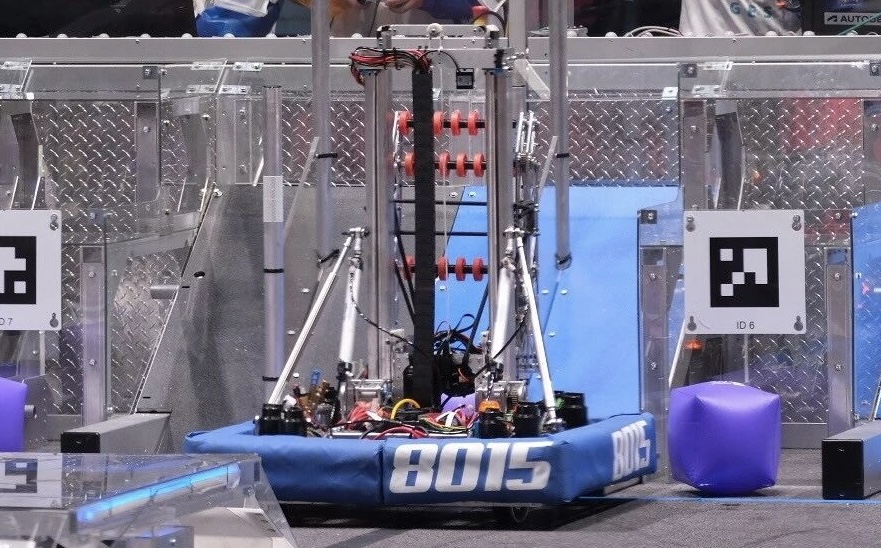 Team 8015 competition robot on the 2023 CHARGED UP field